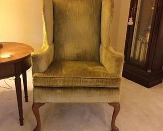 One of a matching pair of velvet wingback chairs.