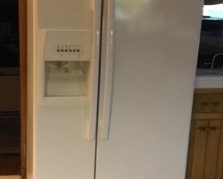 Whirlpool side by side refrigerator/freezer with ice maker.