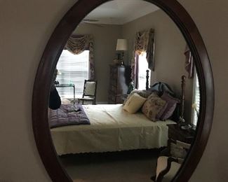 Wood framed oval wall mirror 
