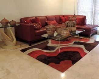 LEATHER SECTIONAL SOFA, GLASS COFFEE TABLE AND RUG