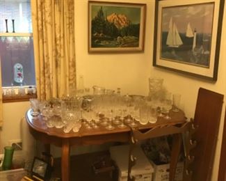 Dining Table with leaf, crystal, framed prints, rifle or pool cue rack, misc.