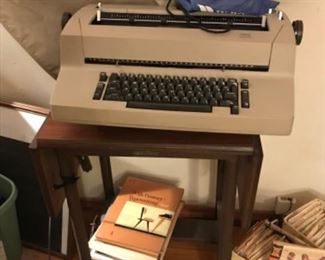 Typewriter with supplies and vintage typing book. Vintage rolling stand.