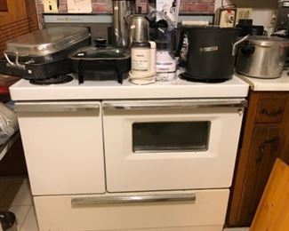 This range is fully functional, clean and adorable! Storage drawer on left side and underneath. 4 eyes with a large center surface. Manuall, extra fuses and range parts included. There is a small rusty spot on very bottom of front that needs painting to make perfect.