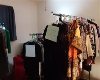 3 large racks of mostly women’s large/x-large clothing. 