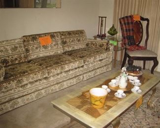 Sofa with mahogany chair and marble top coffee table