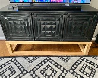 Carved sideboard in hand rubbed black with teak base