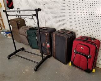 Lot # 253 - $75  SIX pieces of luggage and Adjustable clothing rack & hanging door hanger for clothing (hanging on the rack)