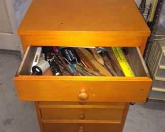 rolling cabinet - filled with art supplies, brushes, paint