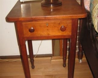 One of several small mahogany, cherry or pine tables
