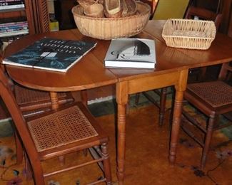 Drop leaf table. Cane seat chairs