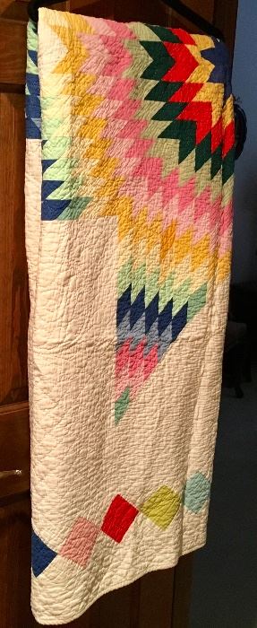 ONE OF SEVERAL ANTIQUE HAND SEWN QUILTS.