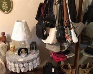 purses, several Sakroot, round bedside table,lamp, brownie camera