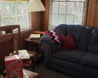 2 oak straight chairs, blue sofa, on left heavy wood floor lamp, endurable with built in lamp