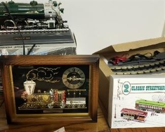 Train clock phone, tracks and two cars