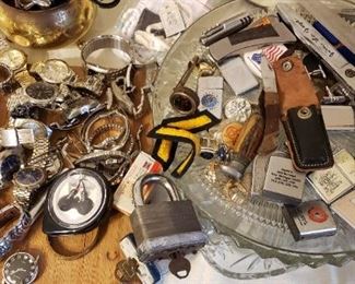 Zippo lighters, watches, knifes, scissors, locks w/keys, medals, cuff links, advertising measuring tapes, old compass, rings costume, except one turquoise band.  Watches include Benrus, seiko, timex, bum, geneva, hampton, jules, bulova, lorus