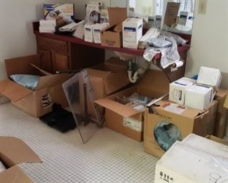 Boxes and boxes of medical supplies, gauze, pads, Qtips, lift brackets and chains with carrying tarp, syringes, and more