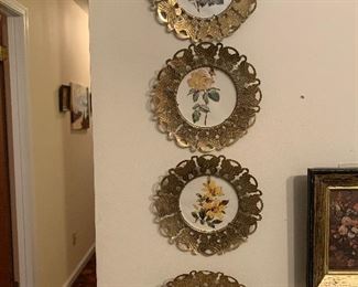 Set of four floral and brass plates $5