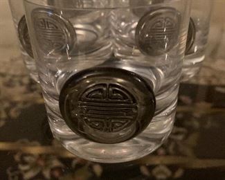 Set of five small drinking glasses with Asian disk on front $8