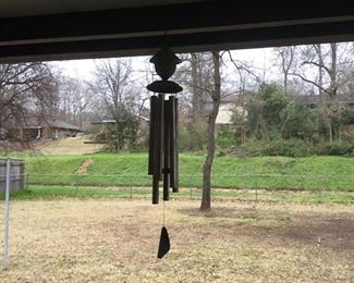 Wind chimes on back patio along with bird feeders.