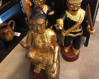 Set of three gold gilt and lacquer carved wood warriors from Nepal.