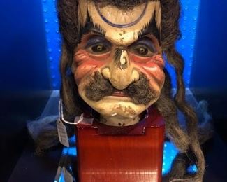 Antique puppet head on stand