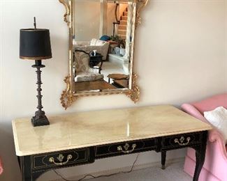Long table with faux marble top by Baker Furniture; ornate wall mirror.