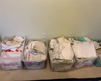 Bins full of vintage lace, dollies, linens, aprons, tablecloths, etc.