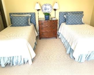 set of twin beds with the upholstered headboards