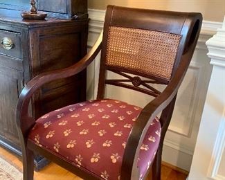 The dining table has 4 cane-back arm chairs and 2 side chairs made by Palecek