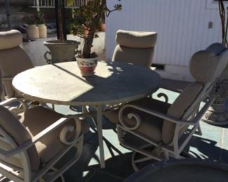 Round Patio table and four swivel rocking chairs, nice!