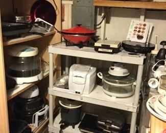 Loads of kitchen small appliances include woks, crock pots, steam ovens, waffle maker, Nuwave, etc.