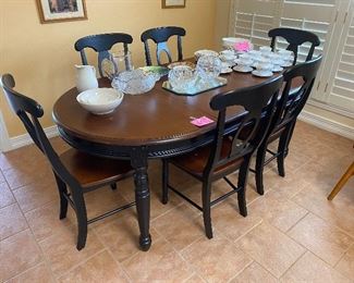 Nice distressed look dining table with 6 chairs and 2 leaves!