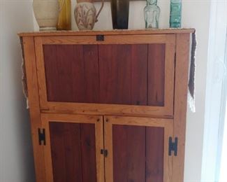 Unique Bar/Wine Cabinet with Drop Down Top.  Bottom holds 15 bottles of wine