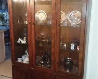 Henredon campaign furniture. 
Curio cabinet with glass shelves, and is lighted. 