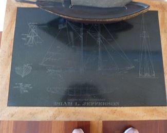 The other table with the ship etching.