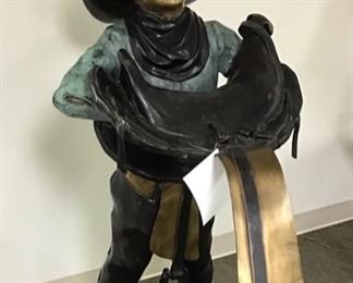 This little cowboy is ready to saddle up. Solid Bronze. 51” tall, 32” deep, 29“ wide