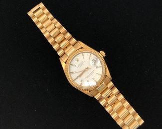 18KT Rolex Oyster Perpetual with
14 KT band, made in Italy. Keeps perfect time. Extra links.