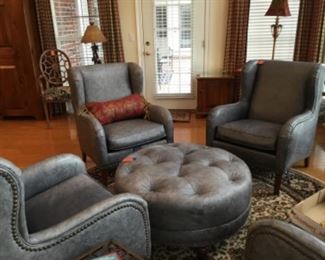 Joe Ruggiero grey leather four armchairs with ottoman. We are selling two armchairs & ottoman Or the whole set. 