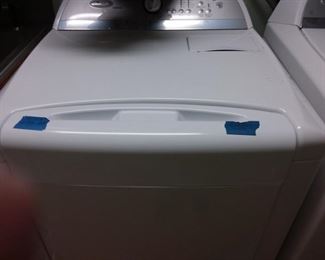 Whirlpool side by side refrigerator with water & ice dispenser(tape denotes side to open)