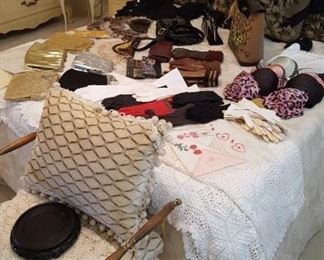 Full size bed full of vintage purses, gloves, lingerie