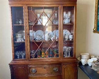 Solid Wood China Cabinet: Clear Glass, 3 Shelves, 3 Drawers, 2 Cabinets, each Cabinet has 2 Shelves. Displayed in the Cabinet assorted Japanese inspired dishware, silver goblets.
