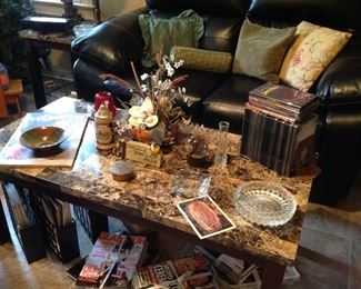 Coffee table, floral arrangement, CDs, vintage ashtrays, brass trinket box, magazines