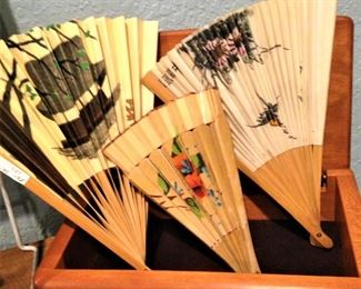 Decorative fans in wooden box