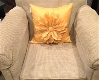 Upholstered chair with decorative pillow