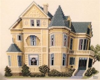 One of three needlepoint framed and matted pictures