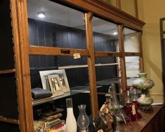 Antique Oak Store Display Cabinet-2 Sections, 20' 10" Long, 36" Depth, Height of Base 32", 93" Tall, 14 Doors.  There are 6 Glass Doors That Extend Upwards 52 Additional Inches From Cabinet (1 Missing), Lighted Case