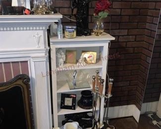 Lot 814 White Mirrored Fireplace Surround, White Shelves- Wooden white mirrored fireplace surround approx 7ft tall and 5ft wide; 8 candle holders; white dish; 4 pieces of clear glassware; two white wooden book shelves; sculpture; wall lamp with two lights; floral fireplace 