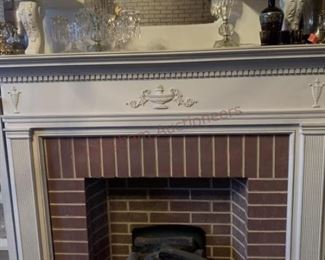 Lot 814 White Mirrored Fireplace Surround, White Shelves- Wooden white mirrored fireplace surround approx 7ft tall and 5ft wide; 8 candle holders; white dish; 4 pieces of clear glassware; two white wooden book shelves; sculpture; wall lamp with two lights; floral fireplace 