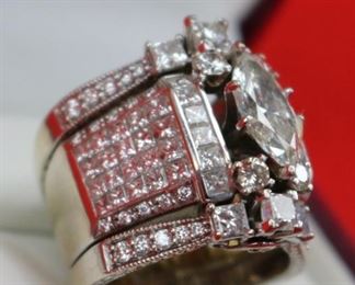 Lot 832 Ring-14K White Gold Band With Center Stone 2.01K- Ladies multi rings  put together, center ring is 18k white gold has a 2.01ct Marquise center diamond I/SI2 GIA cert#1162577946 with 50 side princess shape diamonds @ 2.90cttw G/Si1, 20 round diamonds @ .18cttw G/SI1i quantity of 4 round diamonds @ .13ct each G/SI2 for a total weight of .52cttw.  On each side of the center ring is a 14k white gold 3 stone ring each center is 3/8ct princess shape HI/I2 and 2 princess shaped diamonds @ 3/8cttw HI/I2 with 10 round diamonds @ 1/5cttw HI/I2, for a total for both rings @ 2.00cttw.