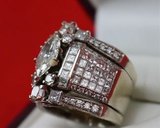 Lot 832 Ring-14K White Gold Band With Center Stone 2.01K- Ladies multi rings  put together, center ring is 18k white gold has a 2.01ct Marquise center diamond I/SI2 GIA cert#1162577946 with 50 side princess shape diamonds @ 2.90cttw G/Si1, 20 round diamonds @ .18cttw G/SI1i quantity of 4 round diamonds @ .13ct each G/SI2 for a total weight of .52cttw.  On each side of the center ring is a 14k white gold 3 stone ring each center is 3/8ct princess shape HI/I2 and 2 princess shaped diamonds @ 3/8cttw HI/I2 with 10 round diamonds @ 1/5cttw HI/I2, for a total for both rings @ 2.00cttw.